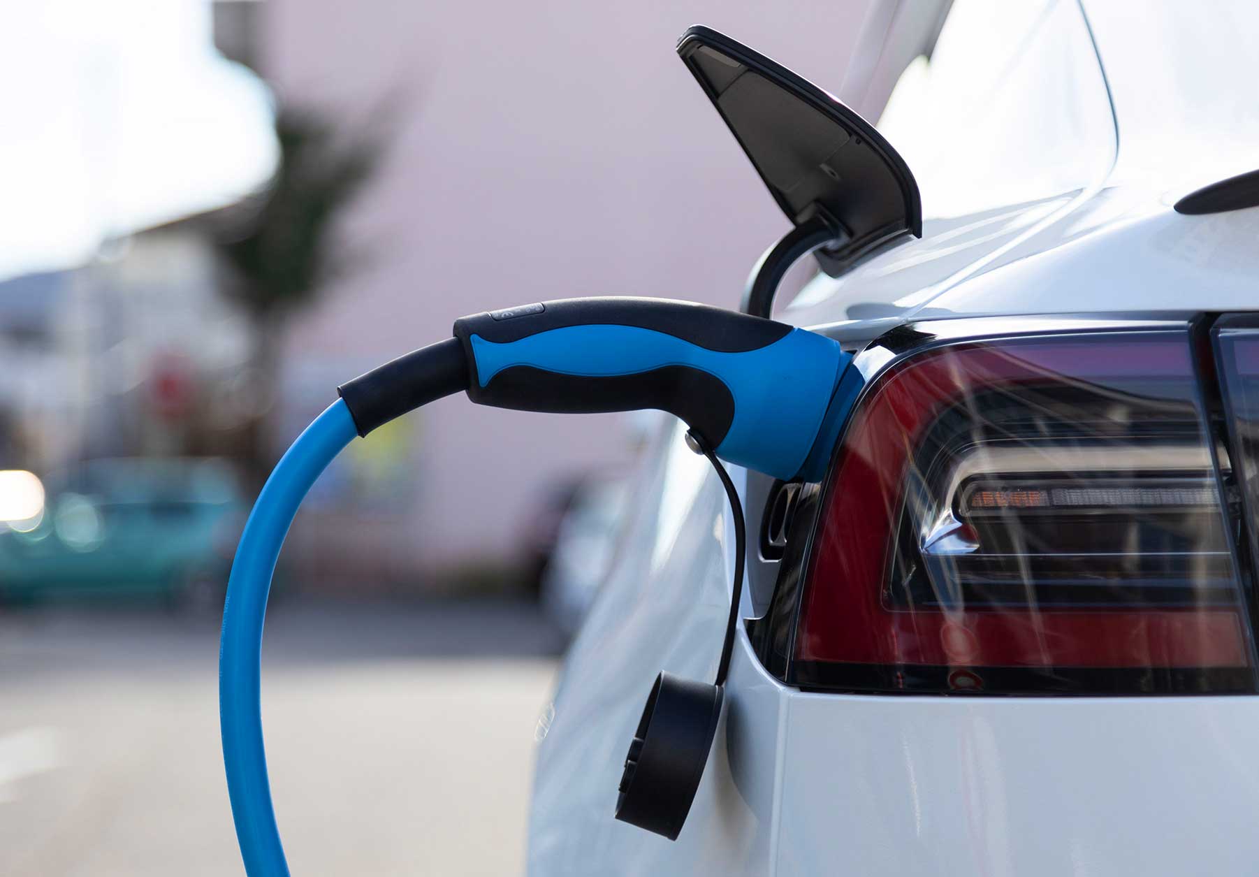 Car being charged at home by EV charging unit