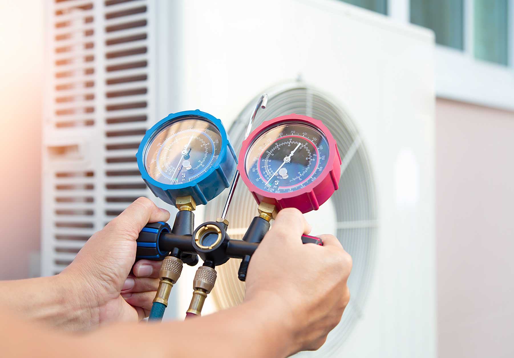 Engineer filling air source heat pump with gas